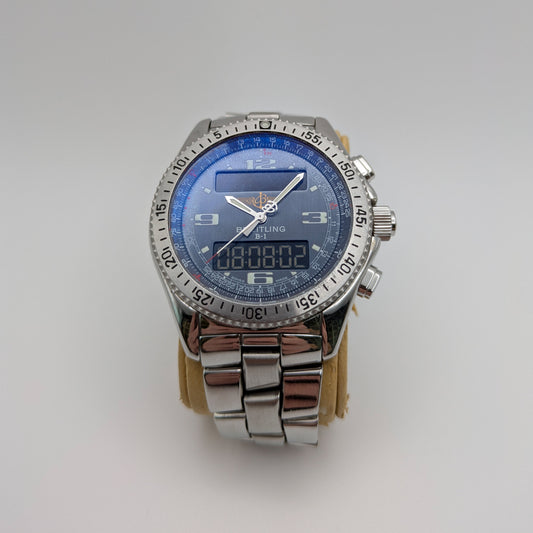 A Breitling B-1 watch with a blue analog dial and digital display, featuring a stainless steel band and case.